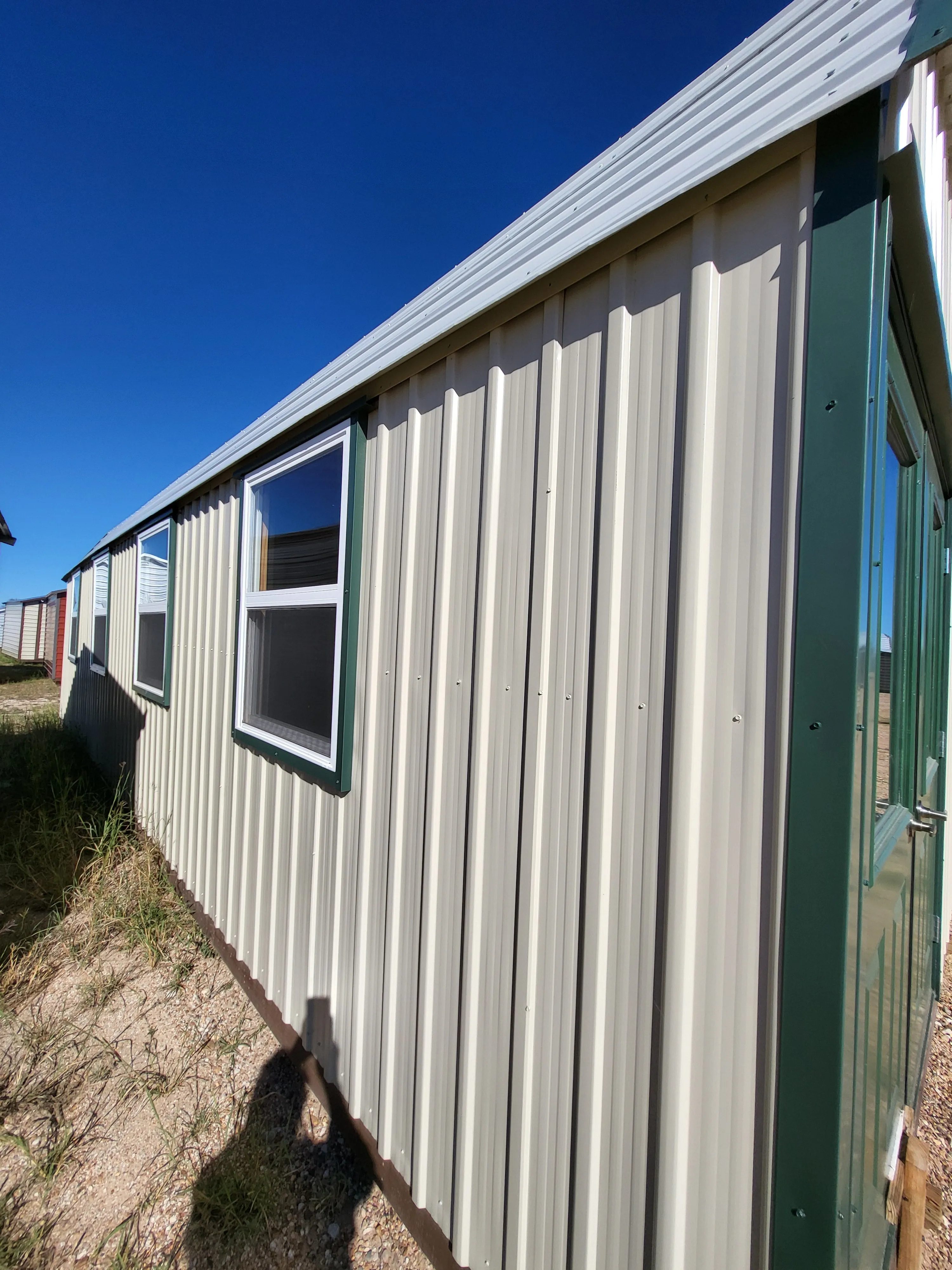 06 x 06 Steel Storage Shed in Tan Siding and Green Trim